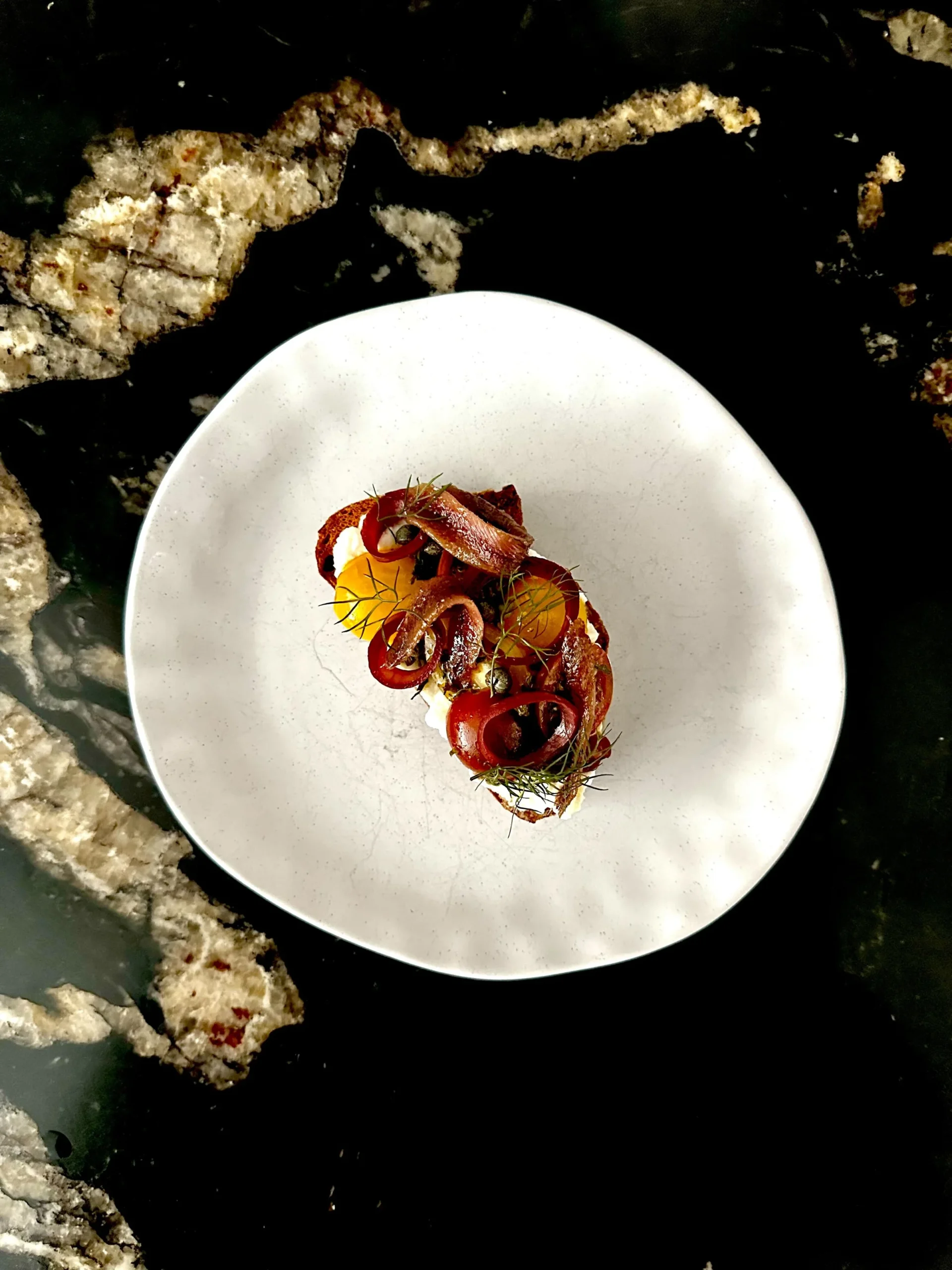 Anchovy crostino with herbs and peppers