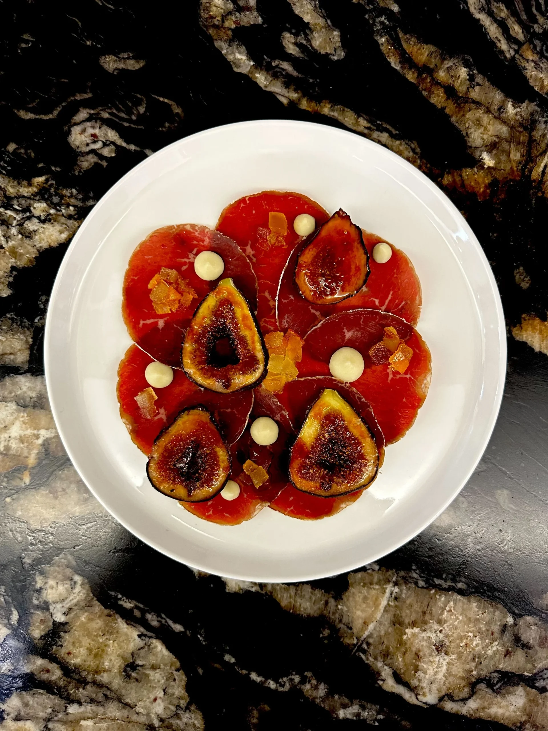 Carpaccio style plate with figs