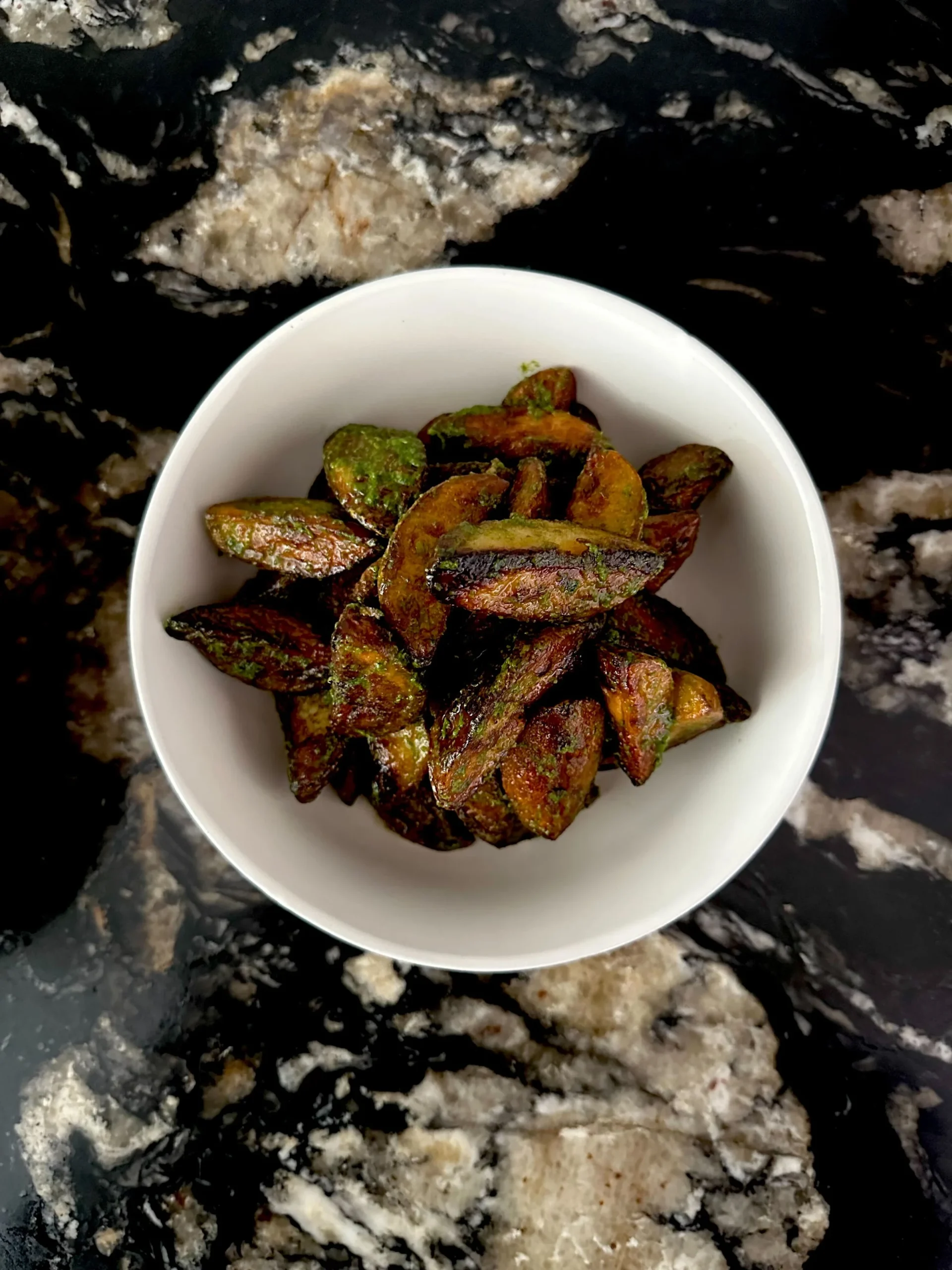 Herb roasted potatoes in a white bowl