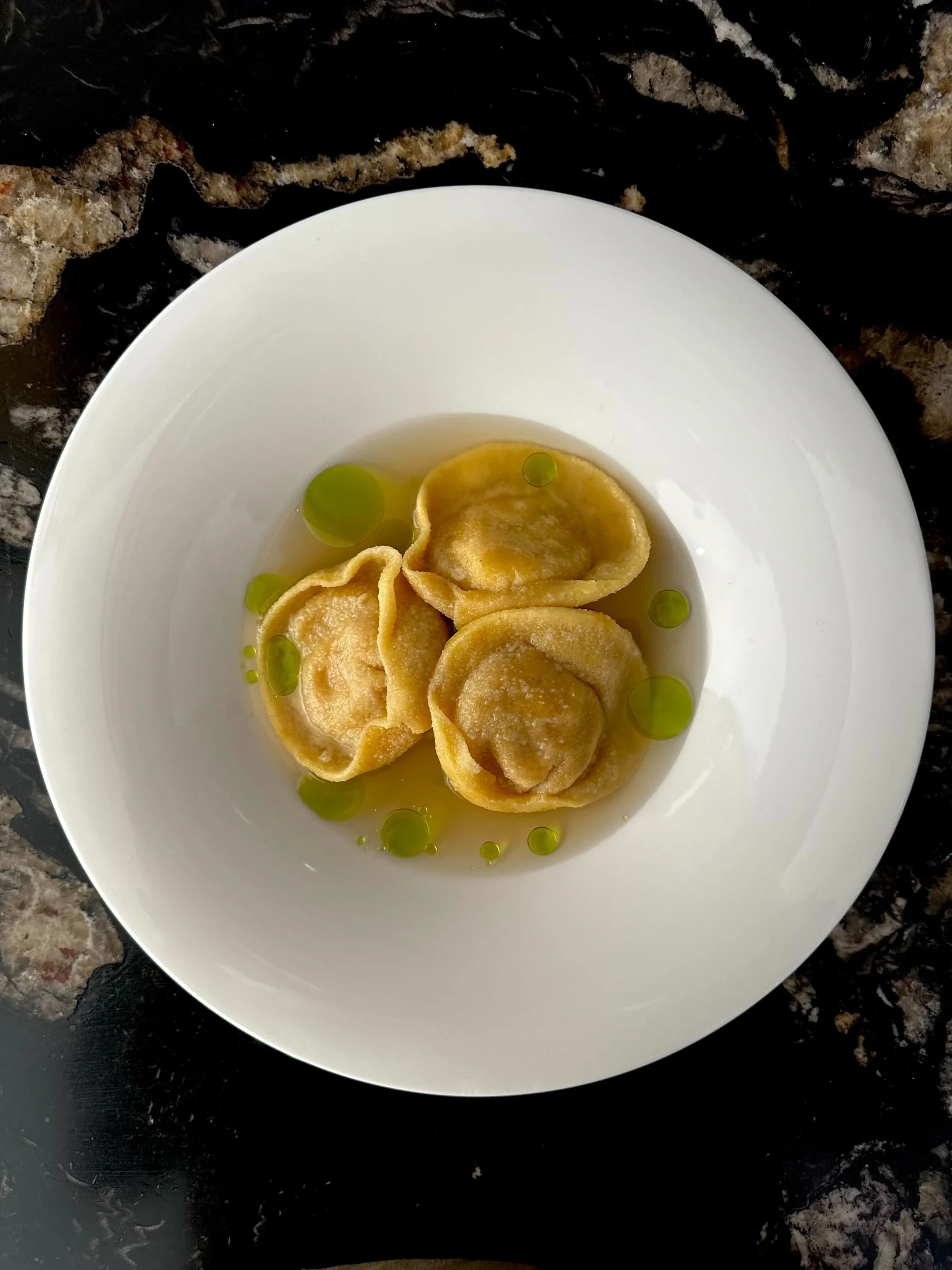 Tortellini served in broth