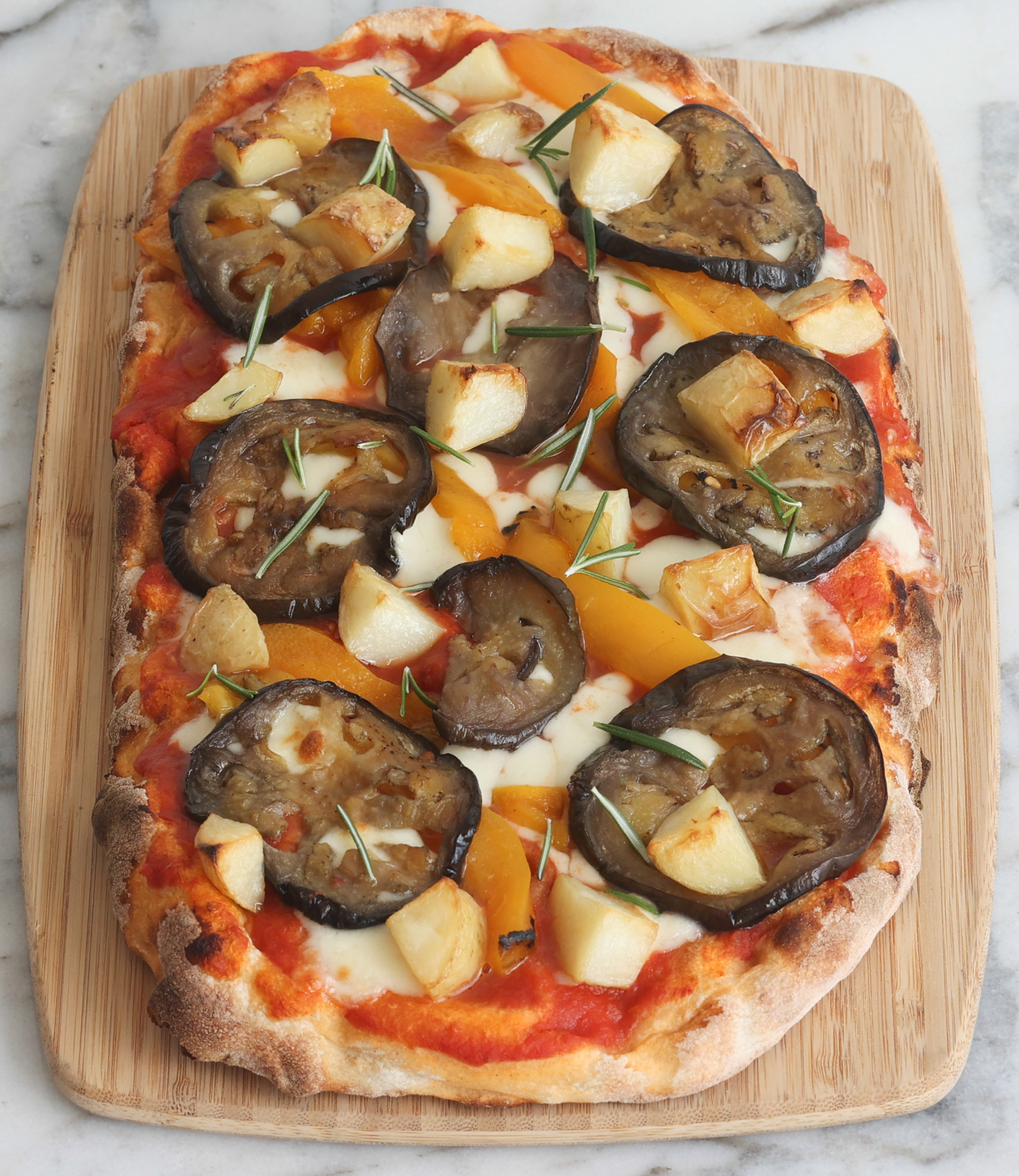 Vegetable pinsa with eggplant, capsicum, potato, rosemary, and mozzarella